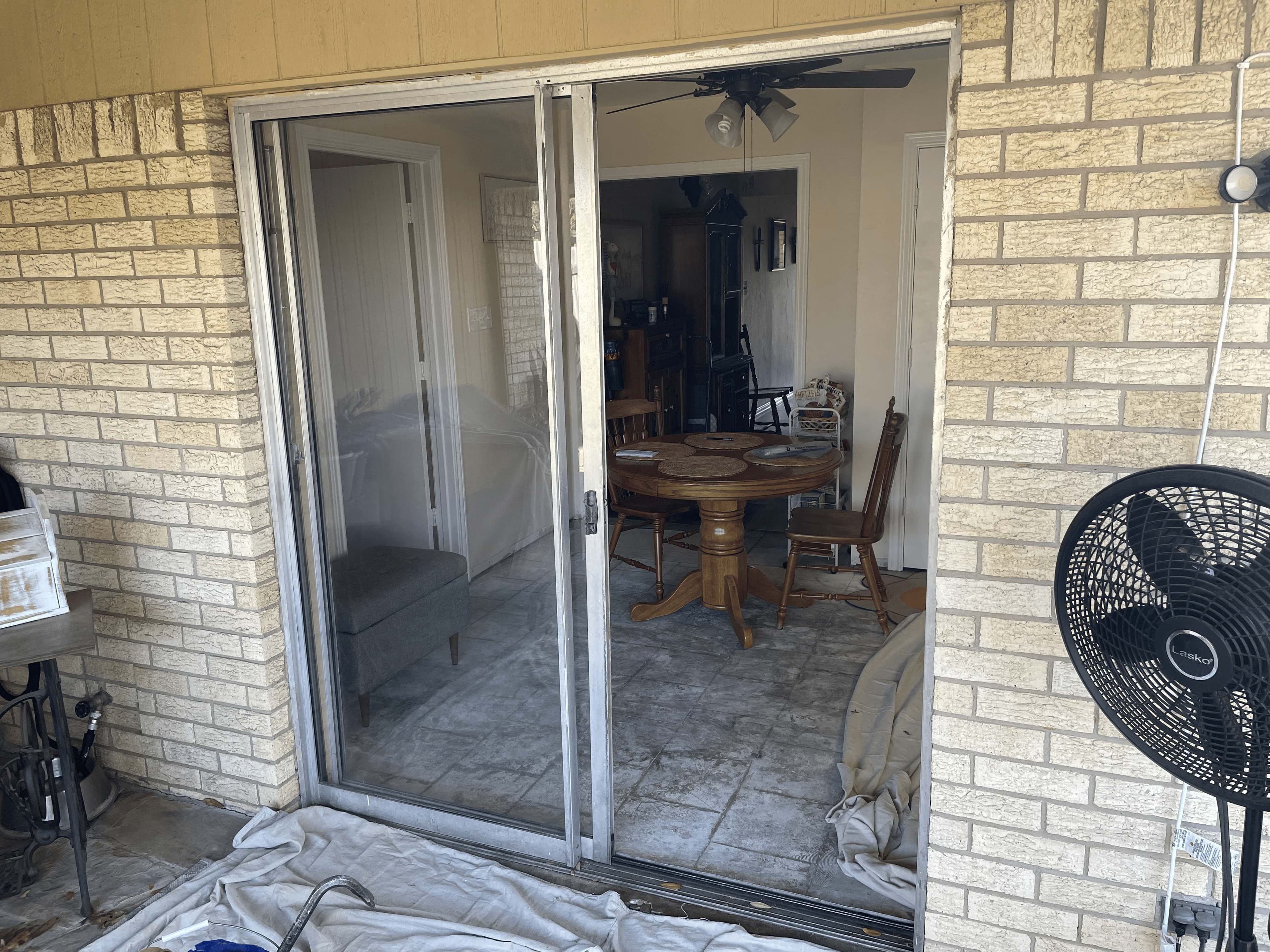 Before: Before and after: old weathered sliding door replaced with new white sliding patio door